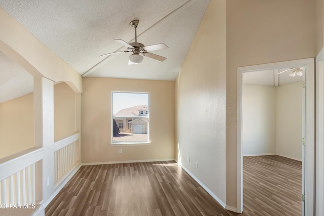 additional living space featuring ceiling fan, a textured ceiling, dark hardwood / wood-style floors, and vaulted ceiling