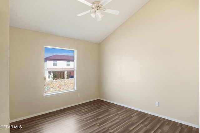 empty room featuring ceiling fan, vaulted ceiling, and dark hardwood / wood-style floors