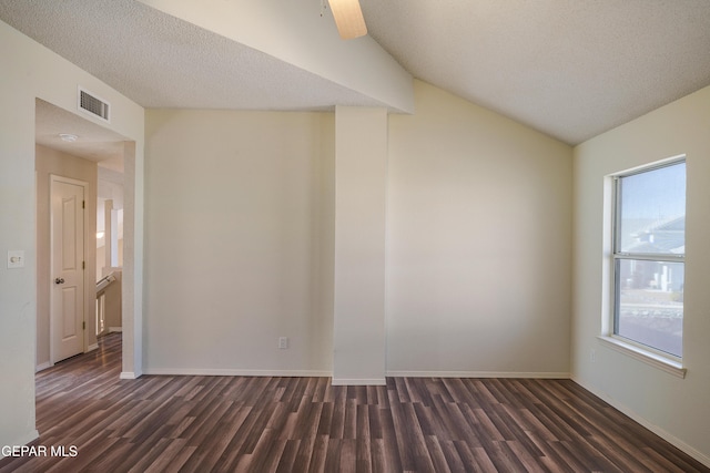 unfurnished room with a textured ceiling, dark hardwood / wood-style flooring, and a healthy amount of sunlight