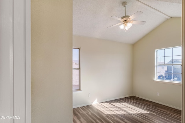 spare room featuring wood-type flooring, a textured ceiling, and lofted ceiling