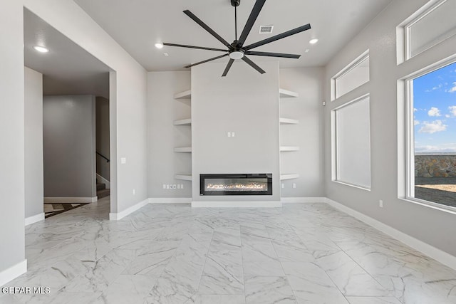 unfurnished living room featuring ceiling fan and built in features