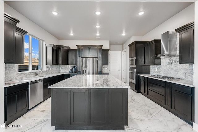 kitchen with backsplash, a center island, sink, stainless steel appliances, and wall chimney exhaust hood