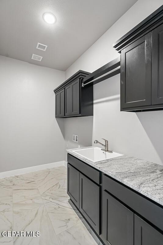 laundry room with washer hookup, sink, and cabinets