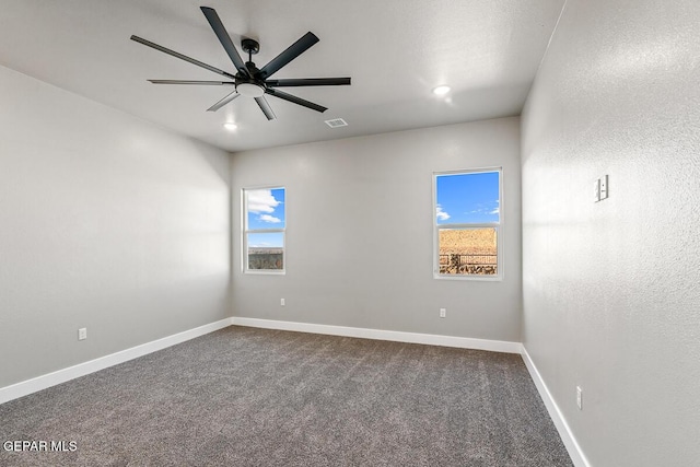 empty room with carpet floors, plenty of natural light, and ceiling fan