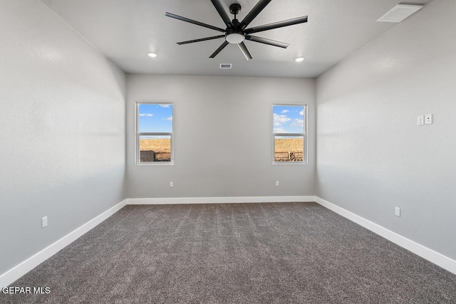 carpeted spare room with ceiling fan and a wealth of natural light