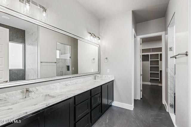 bathroom with a shower with shower door and vanity