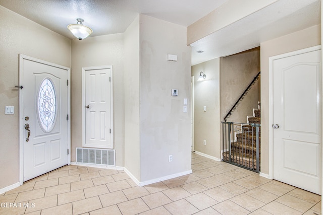 foyer entrance with light tile patterned flooring