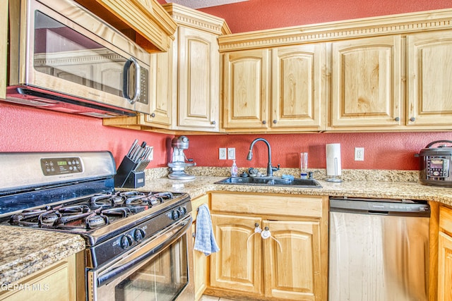 kitchen with sink, light brown cabinets, light stone countertops, and stainless steel appliances