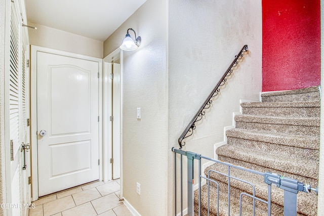 stairs featuring tile patterned floors