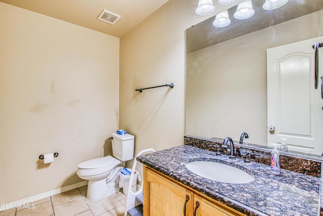 bathroom featuring tile patterned floors, vanity, and toilet