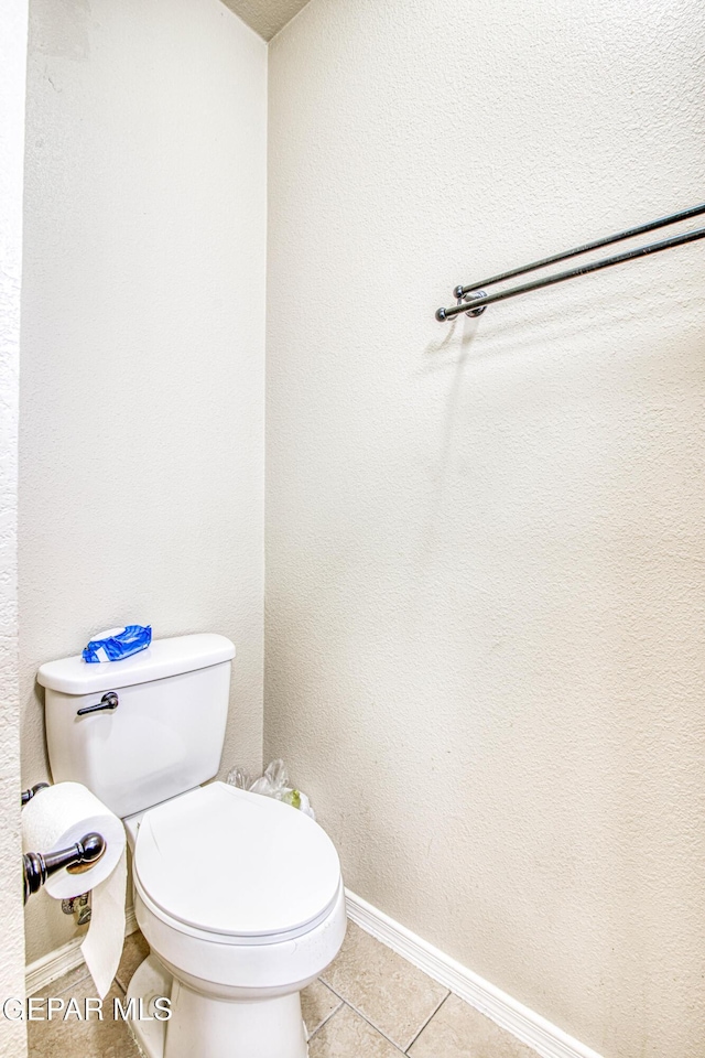 bathroom featuring toilet and tile patterned flooring