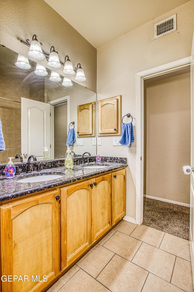 bathroom with vanity and tile patterned flooring