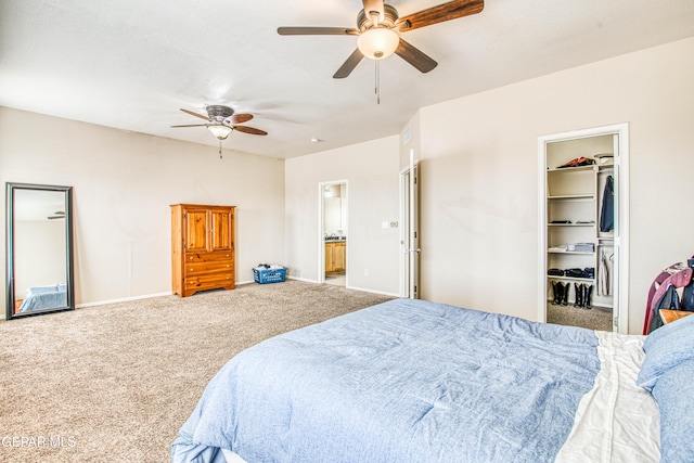 bedroom featuring a walk in closet, a closet, carpet, ceiling fan, and connected bathroom