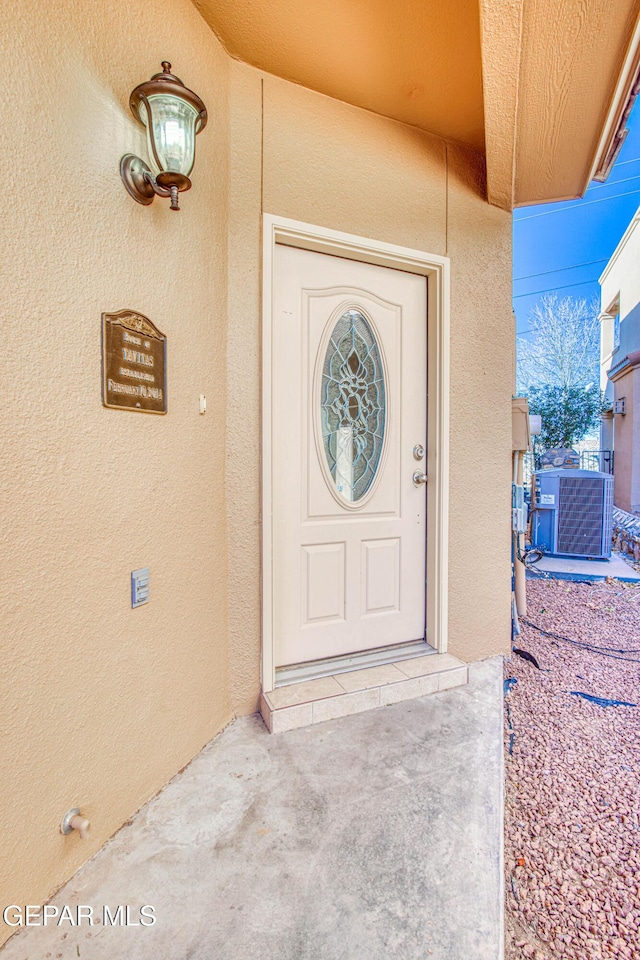 doorway to property featuring central AC unit