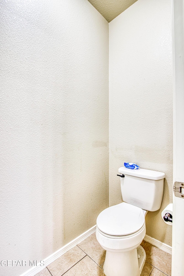 bathroom featuring toilet and tile patterned flooring