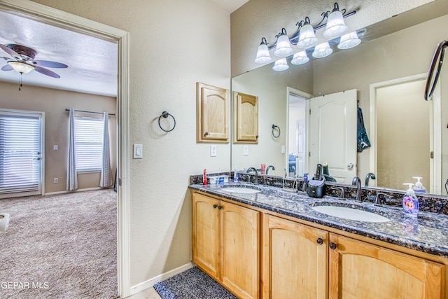 bathroom with ceiling fan and vanity