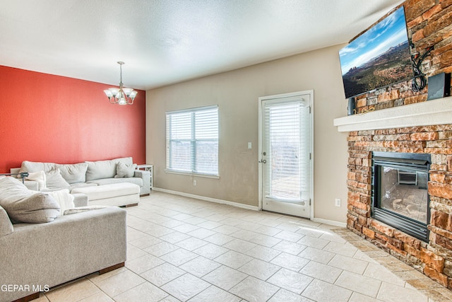 living room with a chandelier and a stone fireplace