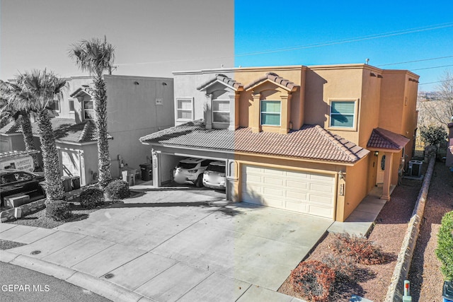 view of front facade with central AC and a garage