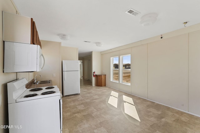 kitchen with sink and white appliances