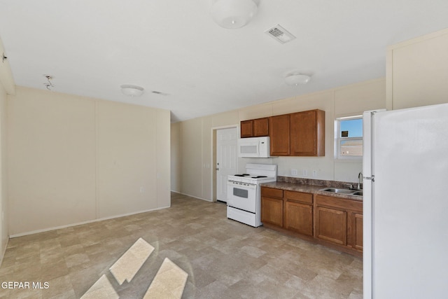 kitchen with sink and white appliances