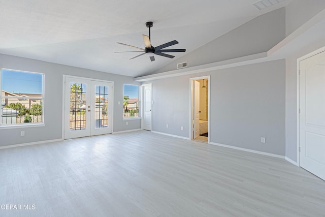 empty room featuring ceiling fan, french doors, vaulted ceiling, and light hardwood / wood-style flooring