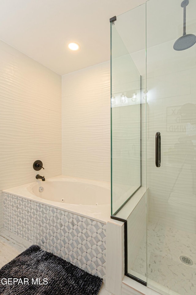 bathroom featuring shower with separate bathtub