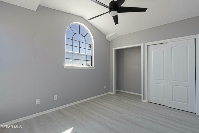 unfurnished bedroom with ceiling fan, light hardwood / wood-style flooring, and lofted ceiling