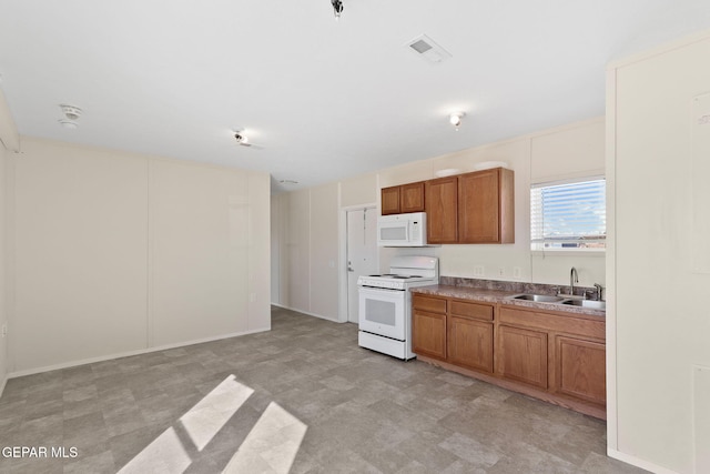 kitchen featuring sink and white appliances