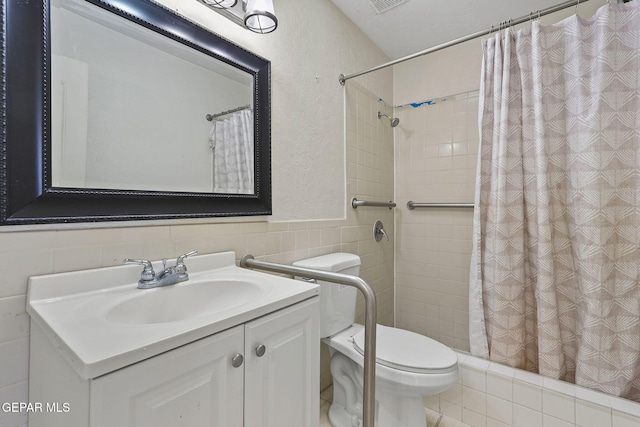 bathroom with toilet, vanity, tile walls, and walk in shower