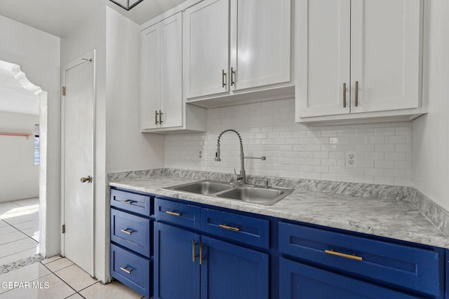 kitchen featuring sink, white cabinets, and light tile patterned floors