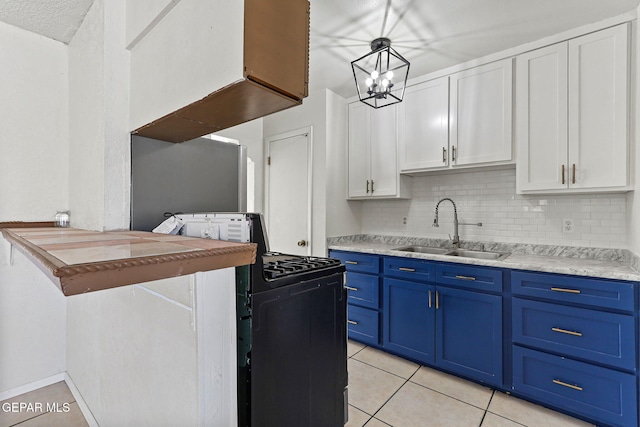 kitchen with blue cabinets, white cabinets, pendant lighting, black gas stove, and sink