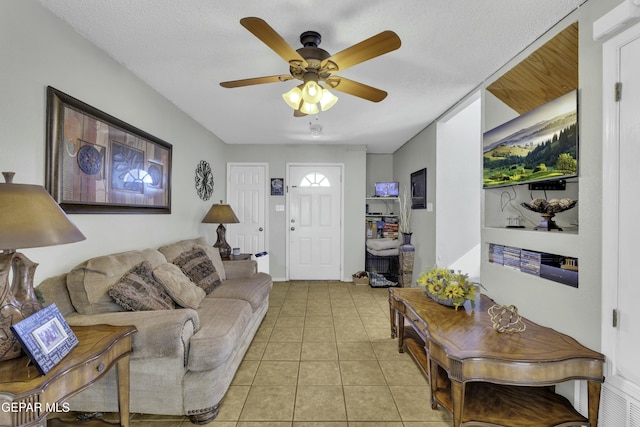 tiled living room featuring a textured ceiling and ceiling fan