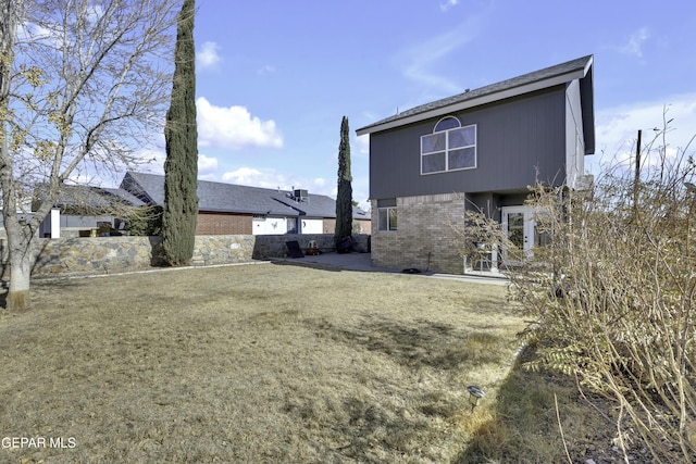 rear view of house with a yard