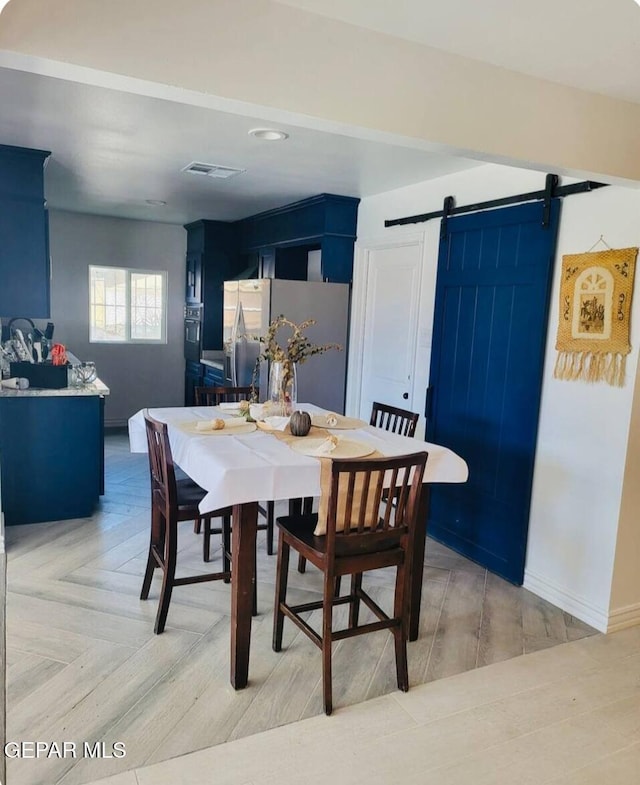 dining area featuring a barn door