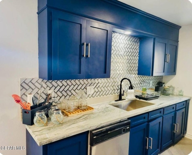 kitchen with decorative backsplash, dishwasher, blue cabinets, and sink