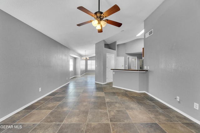 unfurnished living room with lofted ceiling and ceiling fan with notable chandelier