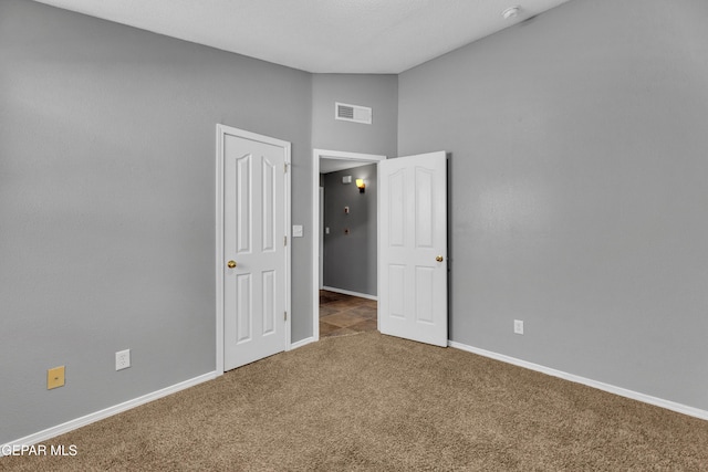 unfurnished bedroom with dark carpet