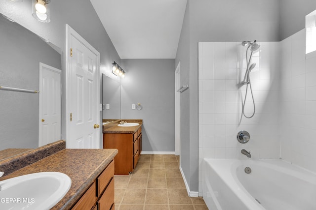 bathroom featuring vanity, tiled shower / bath, and tile patterned flooring