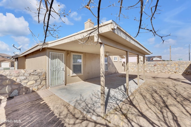 back of property with a patio