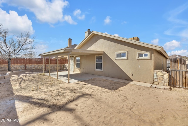 rear view of property featuring a patio area