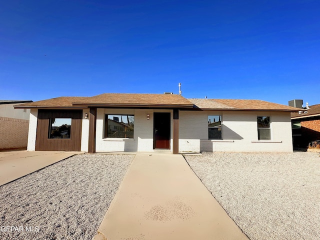 ranch-style home with cooling unit and a patio