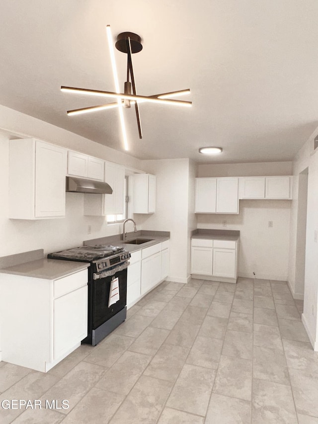 kitchen with sink, stainless steel range with gas stovetop, and white cabinets