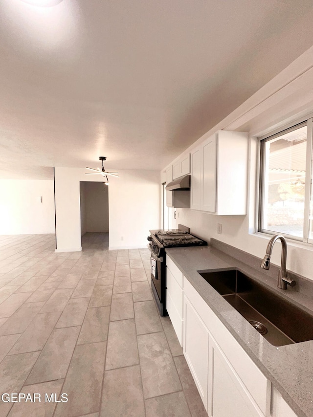 kitchen featuring sink, white cabinets, ceiling fan, light stone countertops, and black range with gas cooktop