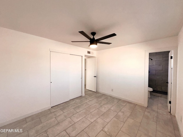 unfurnished bedroom featuring connected bathroom, a closet, and ceiling fan