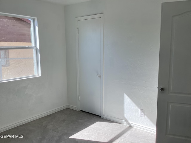 unfurnished bedroom featuring tile patterned floors