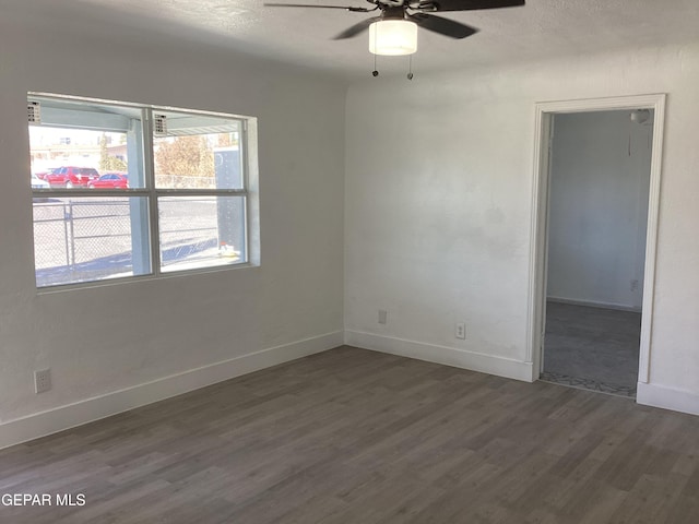 unfurnished room featuring ceiling fan, plenty of natural light, and dark hardwood / wood-style floors