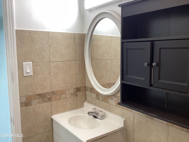 bathroom with vanity and tile walls