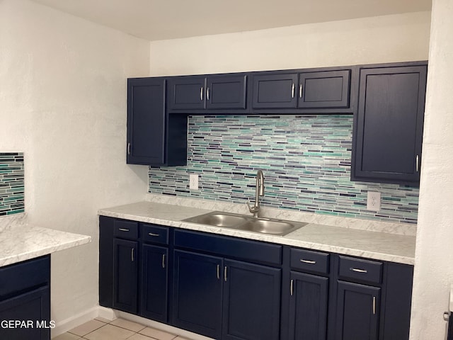 kitchen with sink, light tile patterned floors, and tasteful backsplash