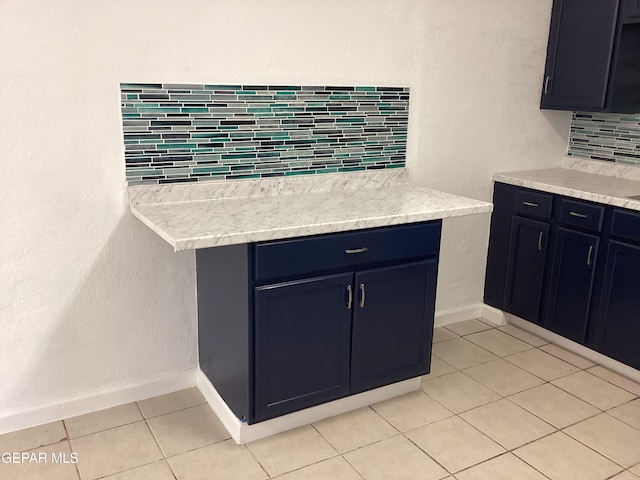 kitchen with tasteful backsplash and light tile patterned flooring