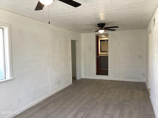 spare room featuring hardwood / wood-style flooring and ceiling fan